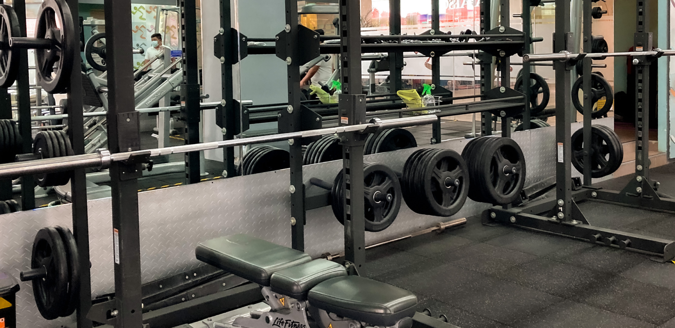 A spacious gym featuring benches, weights, and exercise machines for varied workouts.